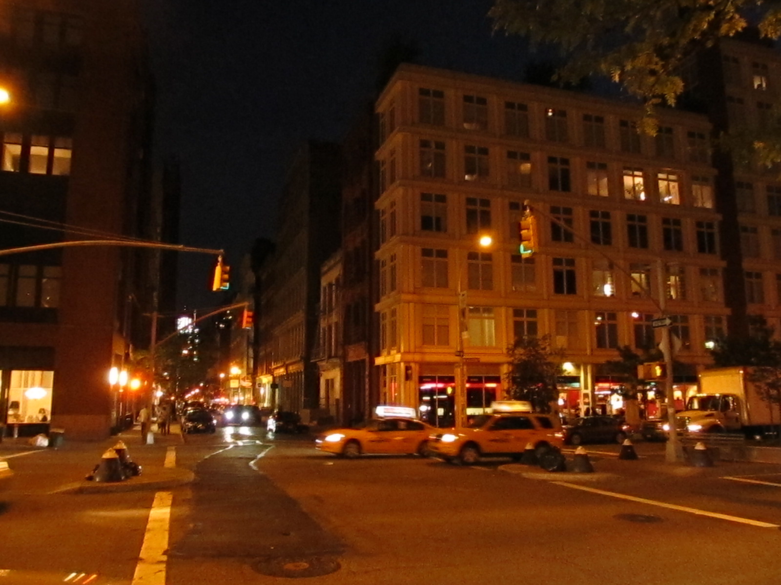 SoHo streetscape at Greene Street with cast-iron architecture and cobblestones